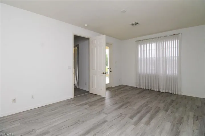 Unfurnished room featuring light wood-type flooring and baseboards
