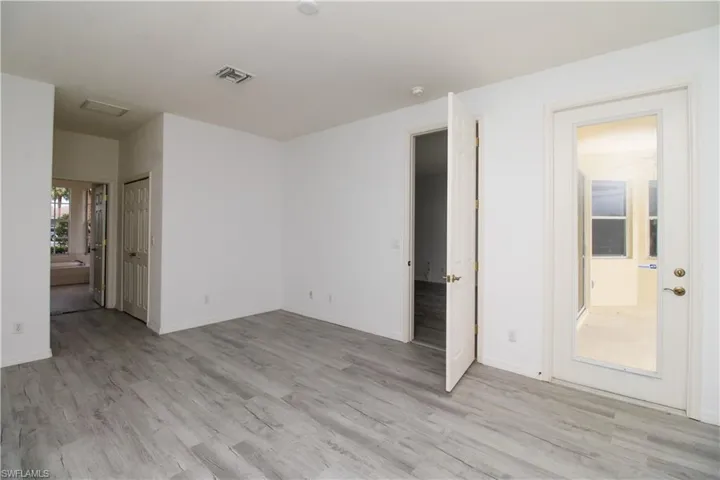 Empty room with light wood finished floors