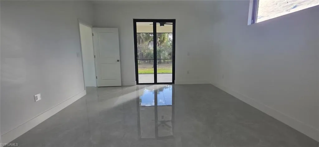 Unfurnished room with baseboards