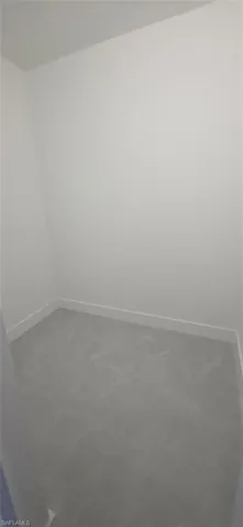 Full bathroom with double vanity and a textured wall