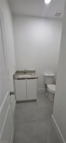 Bathroom featuring vanity and finished concrete flooring