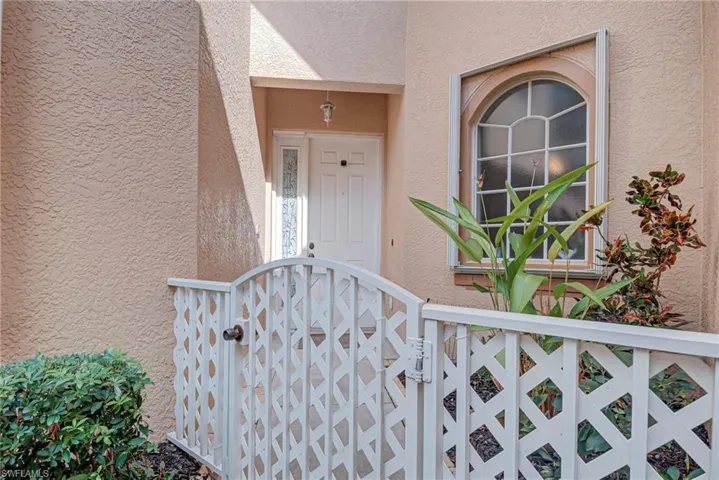 Doorway to property featuring stucco siding