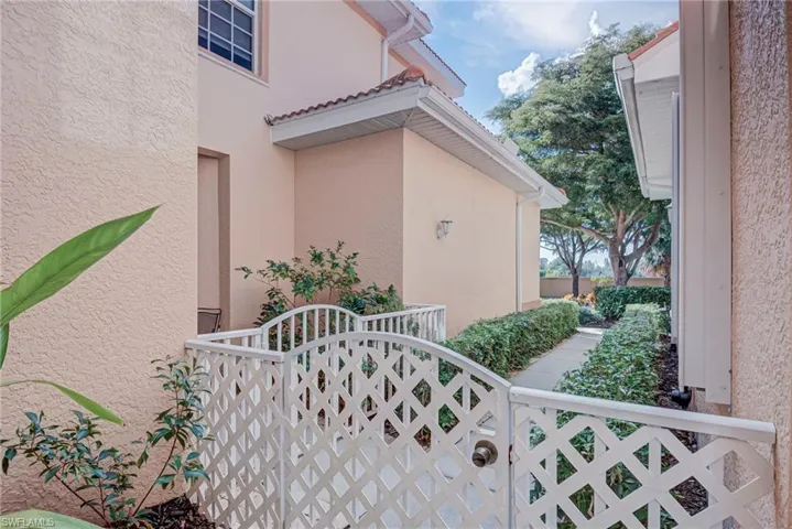 View of property exterior featuring stucco siding and a gate