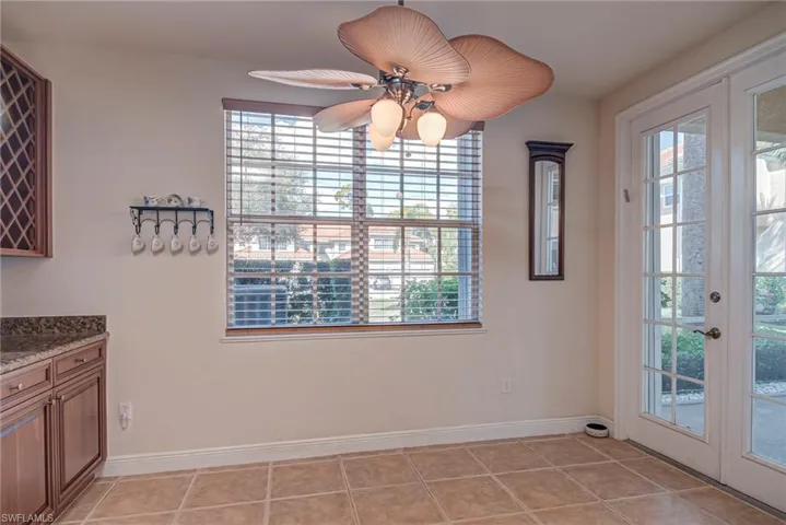Unfurnished dining area with french doors and light tile patterned floors