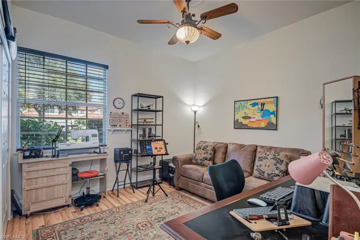 Office area featuring light wood-style floors and ceiling fan