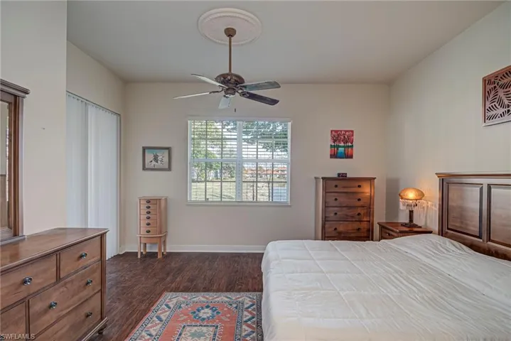 Bedroom with dark wood-style floors and a ceiling fan