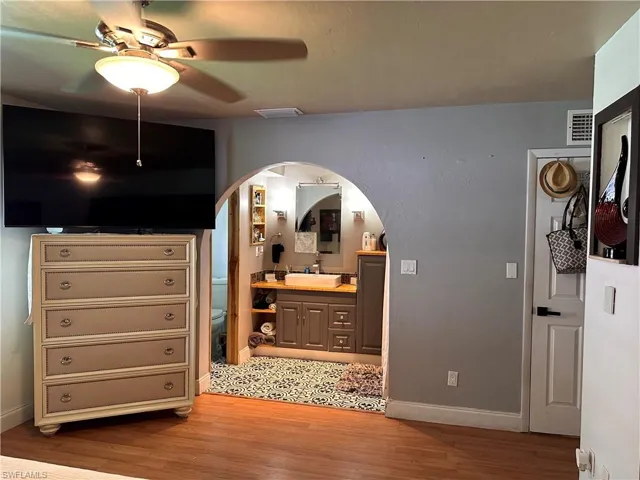 Kitchen with a kitchen breakfast bar, appliances with stainless steel finishes, decorative backsplash, a kitchen island, and white cabinetry