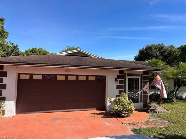 View of front of property with stucco siding, driveway, roof with shingles, and an attached garage