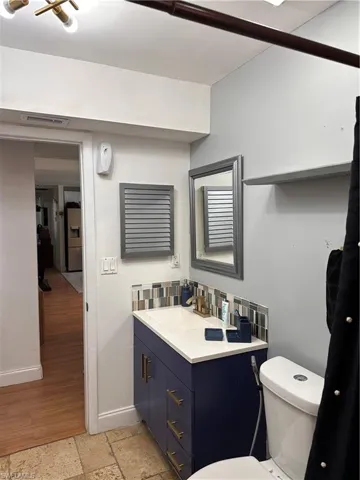 Half bath featuring vanity and stone tile flooring