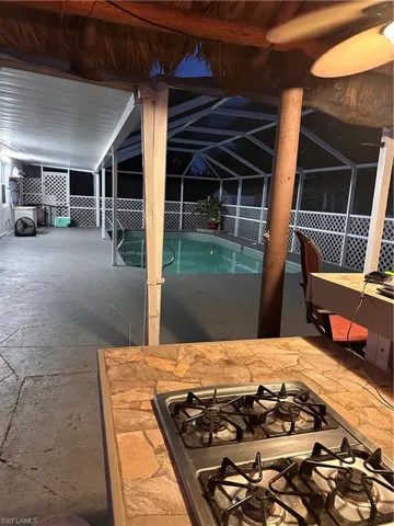 View of patio with a bar and a ceiling fan