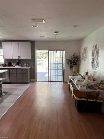 Dining room with light wood-type flooring and a textured ceiling