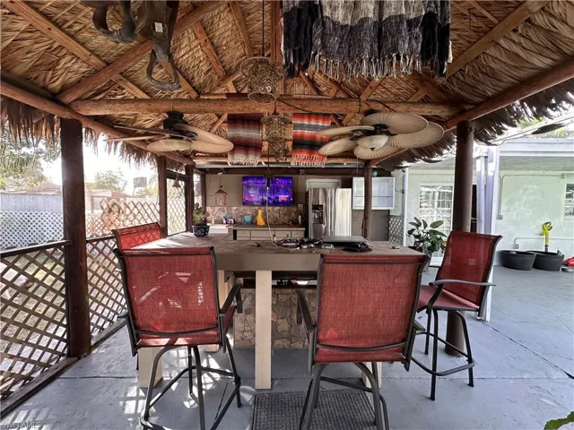 View of patio / terrace with a lanai, a sunroom, and outdoor dining area