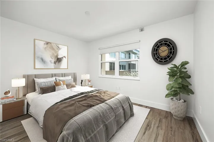 Bedroom with dark hardwood / wood-style flooring