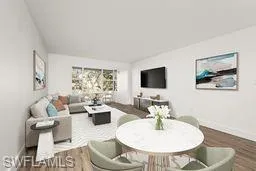 Living room with dark wood-type flooring