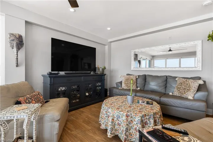 Living room featuring ceiling fan and hardwood / wood-style floors