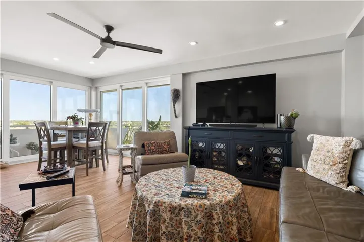 Living room with hardwood / wood-style floors and ceiling fan