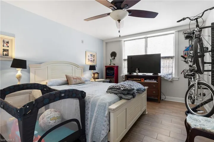 Bedroom featuring multiple windows and ceiling fan