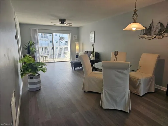 Dining area with dark wood-type flooring and a ceiling fan