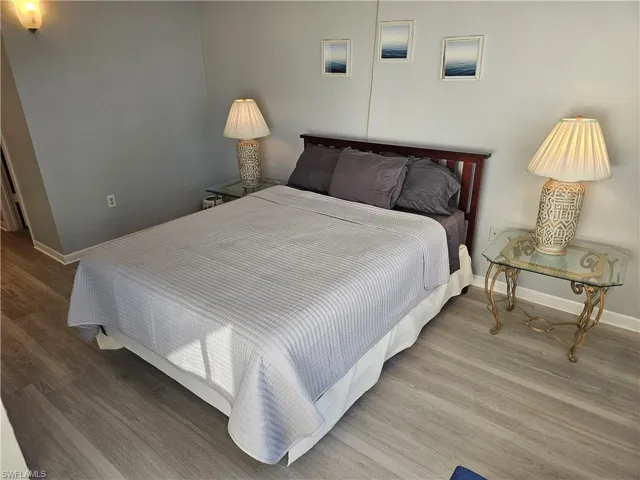 Bedroom featuring baseboards and wood finished floors