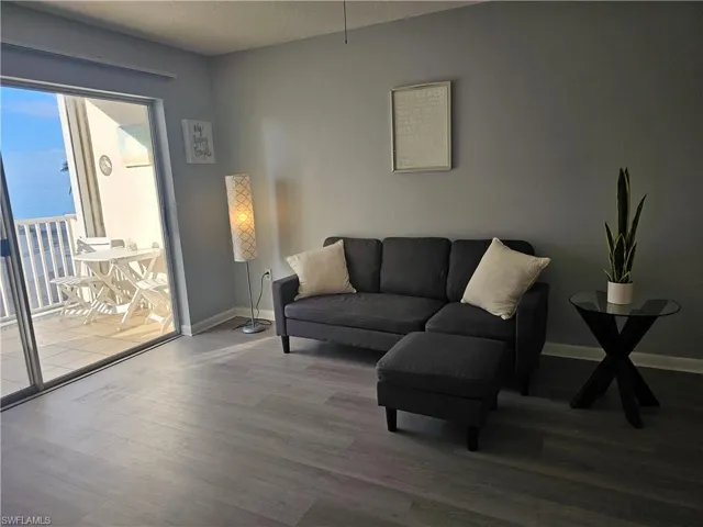 Living room featuring wood finished floors and a textured ceiling