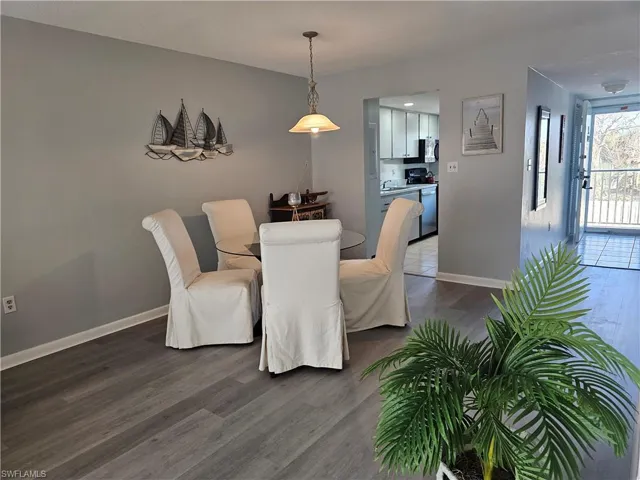 Dining room featuring dark wood-type flooring