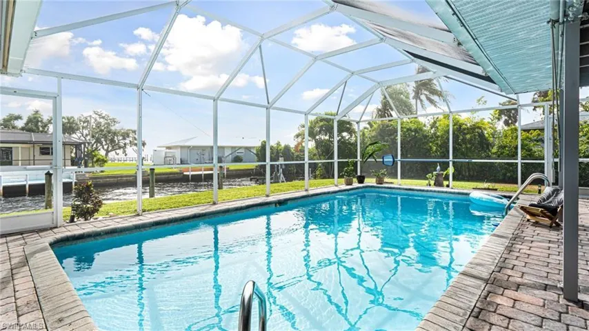 View of swimming pool with a lanai and a patio