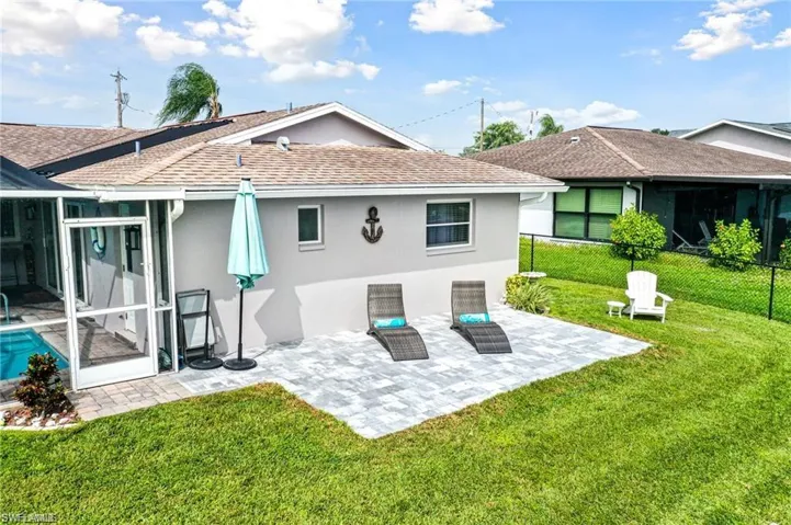 Rear view of house featuring a yard and a patio area