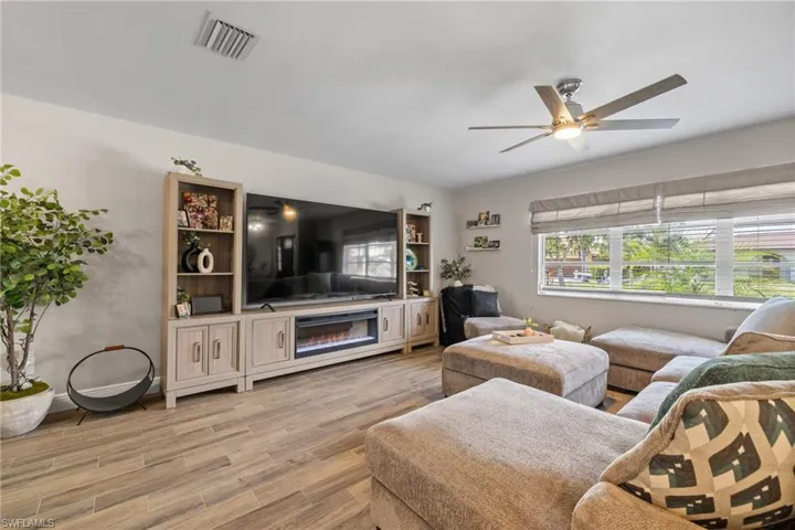 Living room with hardwood / wood-style flooring and ceiling fan