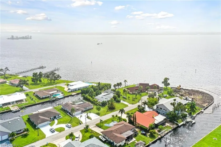 Birds eye view of property with a water view
