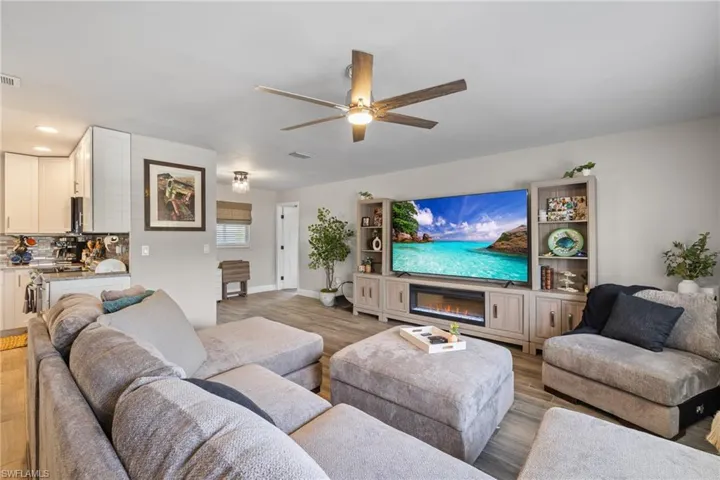 Living room featuring ceiling fan and light hardwood / wood-style floors