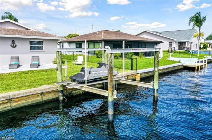 Dock area featuring a water view and a yard