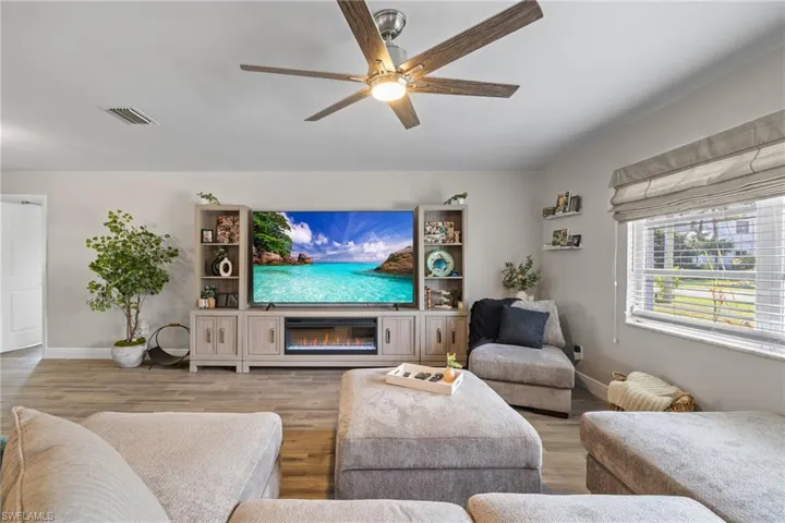 Living room with wood-type flooring and ceiling fan