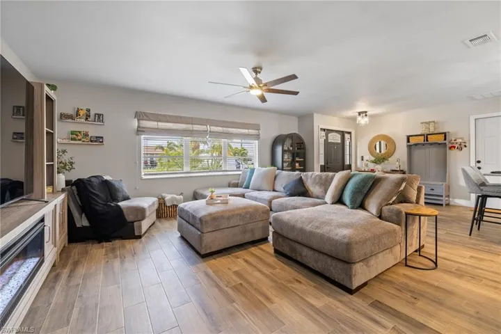 Living room featuring ceiling fan and wood-type flooring