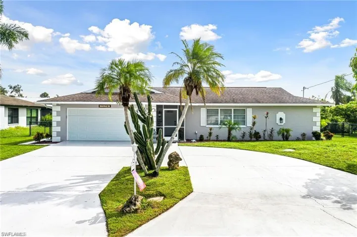 Ranch-style home featuring a garage and a front yard