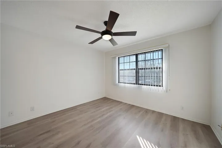 Empty room featuring ceiling fan, light hardwood / wood-style flooring, and a textured ceiling