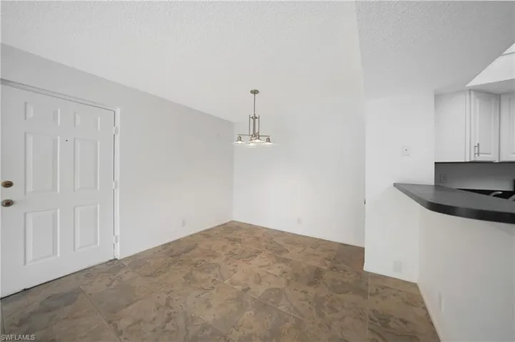 Unfurnished dining area featuring a textured ceiling