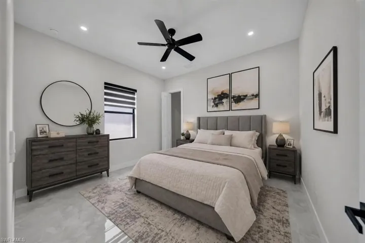 Spacious room featuring light-toned walls, recessed lighting, a ceiling fan, and tile flooring