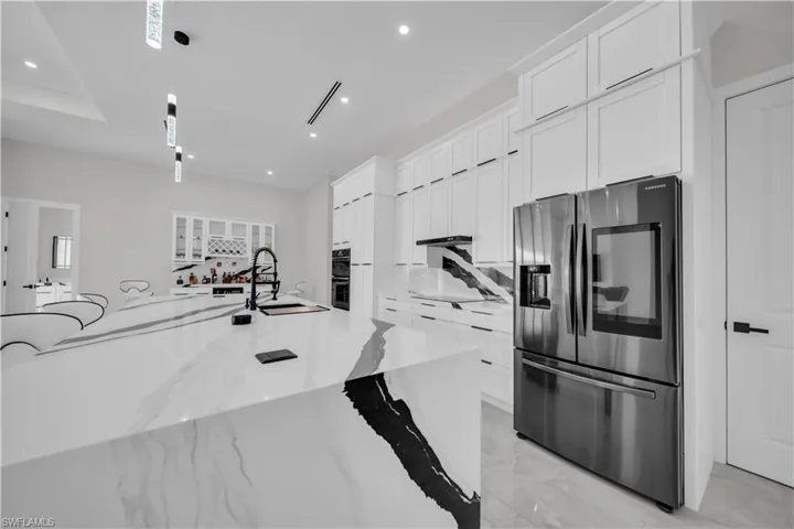 Expansive kitchen island featuring a waterfall edge and statement veining