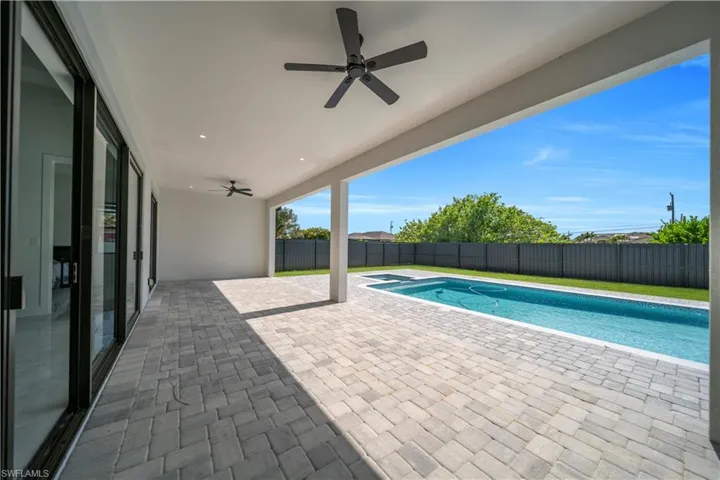 Covered patio with paver flooring, recessed lighting, and dual ceiling fans
