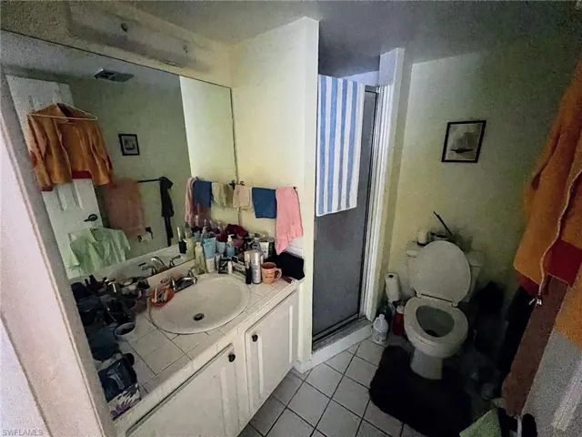 Full bath featuring visible vents, toilet, a shower stall, vanity, and tile patterned flooring