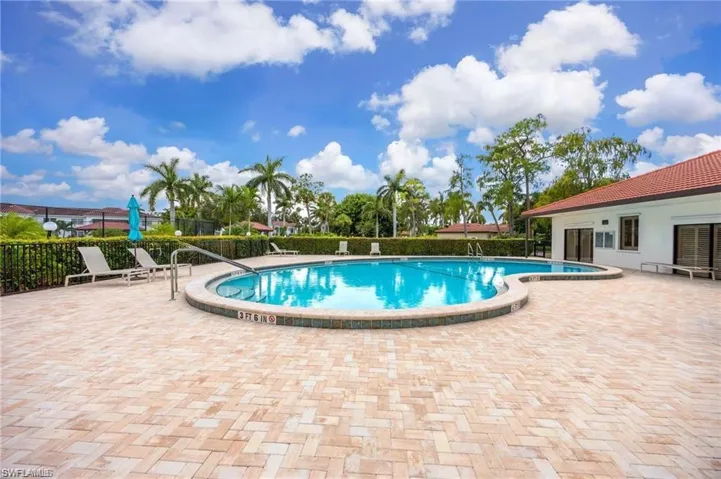 Community pool with fence and a patio