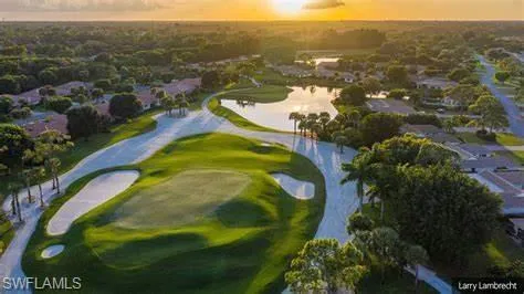 Aerial view at dusk featuring golf course view