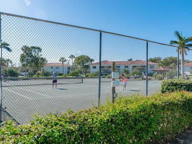 View of tennis court featuring fence