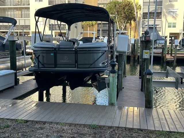 Dock area featuring a water view and boat lift