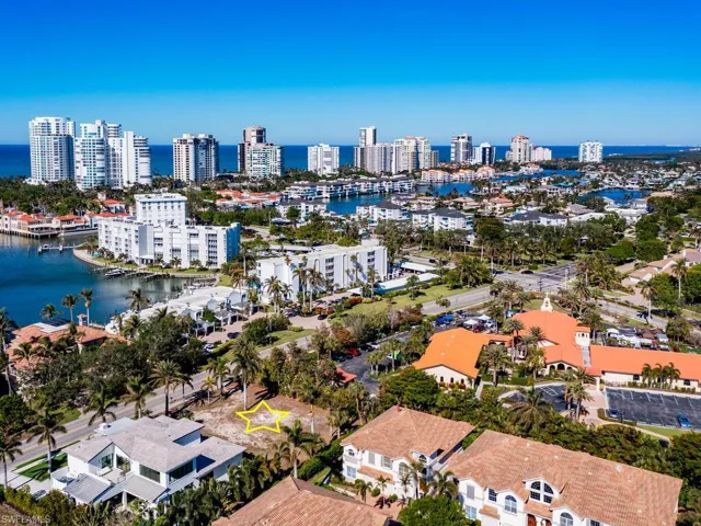 Birds eye view of property with a water view