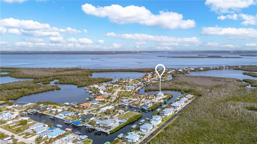 Aerial view of home looking over Matlacha Pass, with Cape Coral in the background.