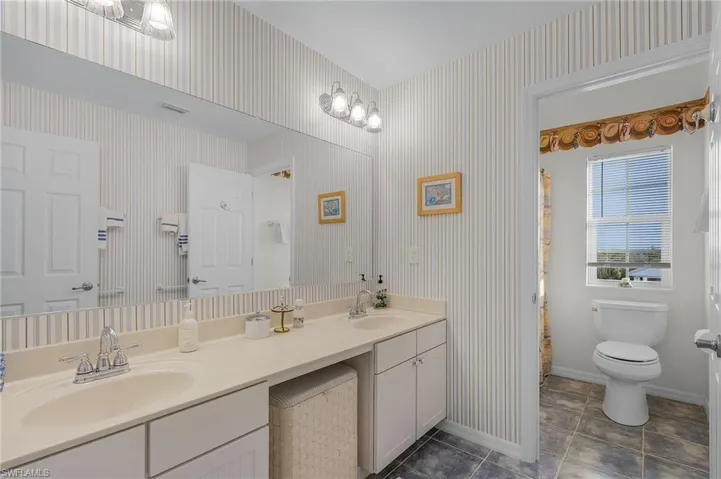 The third-floor guest bathroom has dual sinks, but the shower/toilet area are separate.