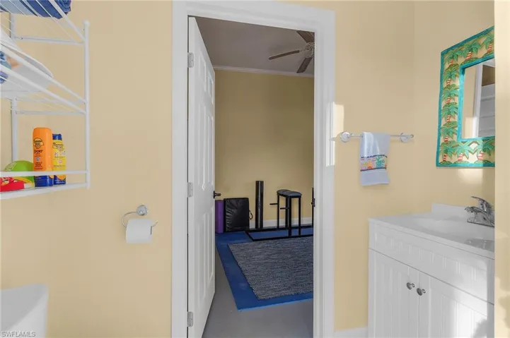 First floor half bath between the exercise room and the pool.