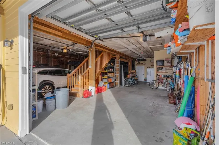 One side of the garage and "stack" up to four vehicles.  There is plenty of room for at least one vehicle and a golf cart on the other side.  There is an "inside" staircase leading upstairs for added convenience.