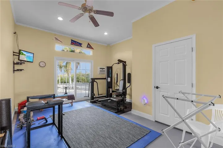Air-conditioned exercise room on the first level with sliders leading to a patio on the east side.  There is also a half bath on this level that also serves as a pool bath.